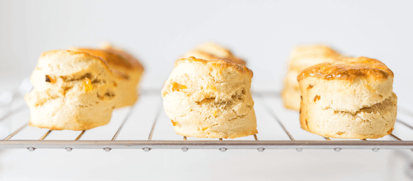 White chocolate scones on a baking rack