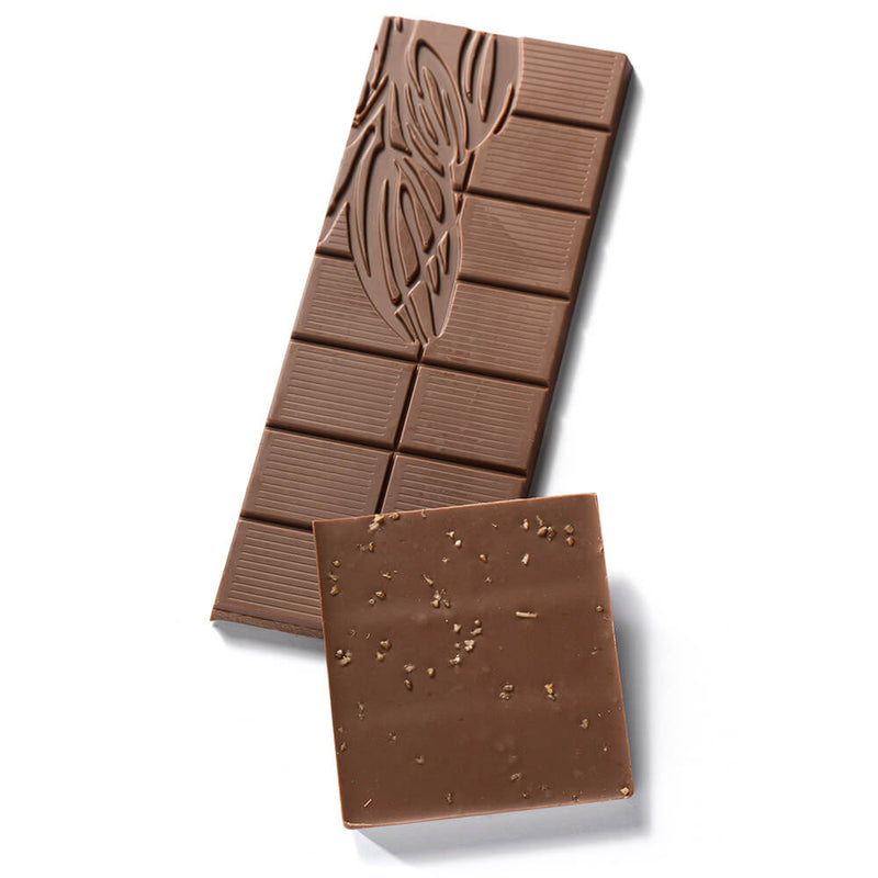 One unpackaged bar of Rosemary Milk Chocolate Fusion, broken in two pieces