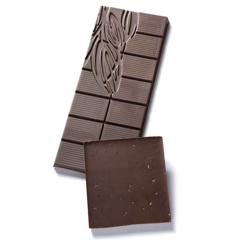 Two pieces of a Dark Chocolate Oregano Fusion Bar