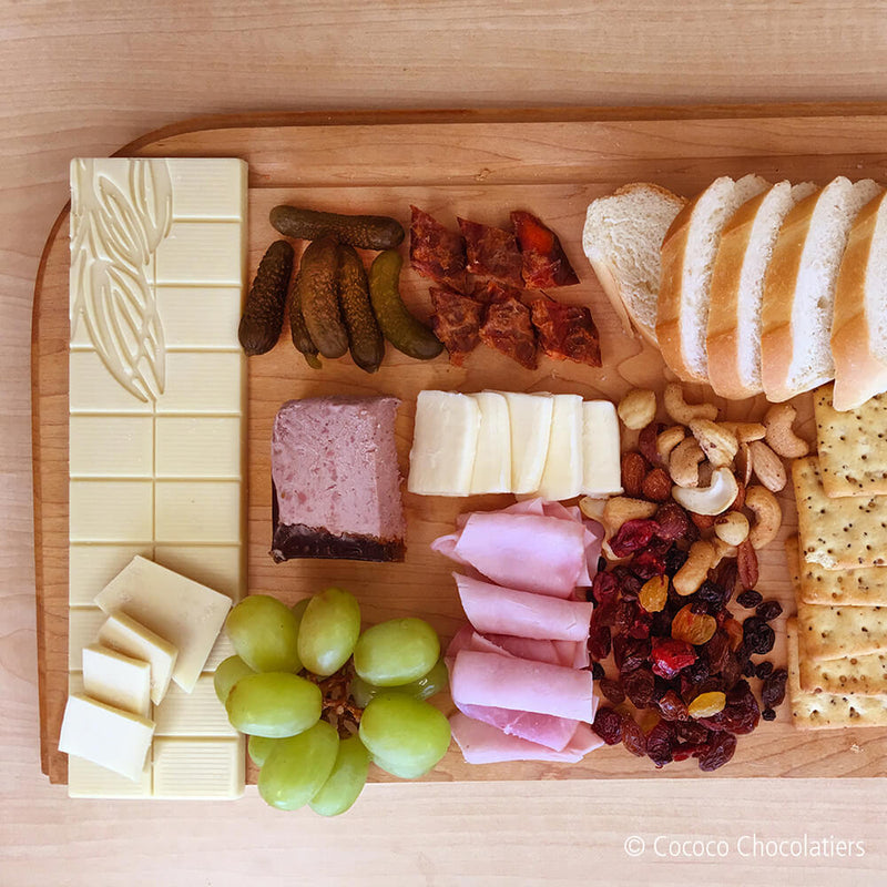 Full charcuterie board with a bar of Dill Fusion White Chocolate