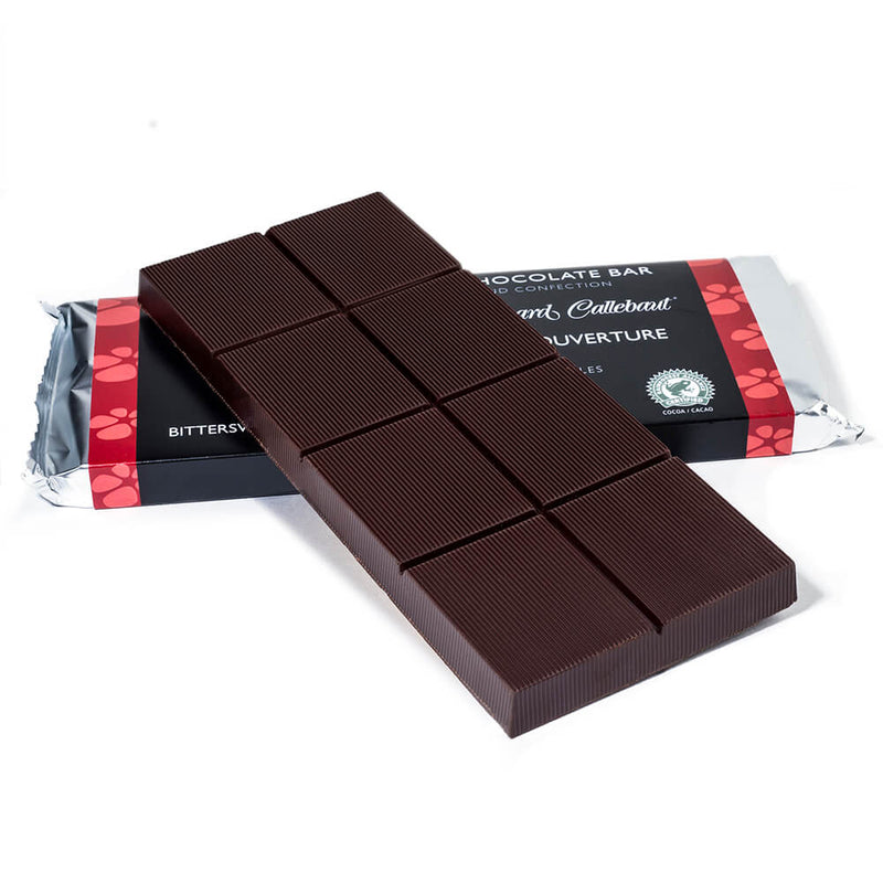 Bitter sweet chocolate baking bar propped up on to a packaged baking bar