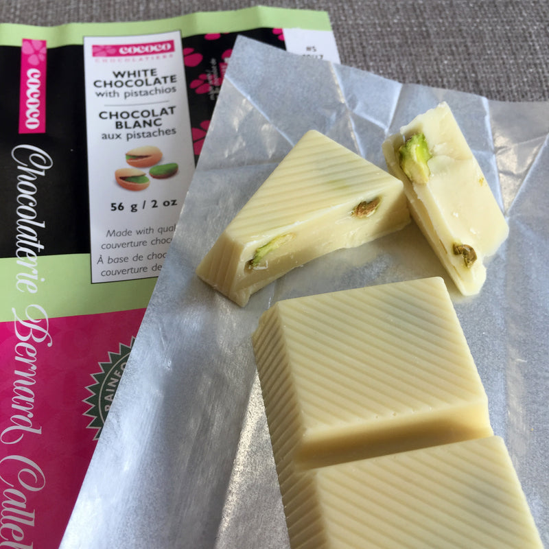 Closeup of an opened bar package of the white chocolate with pistachios
