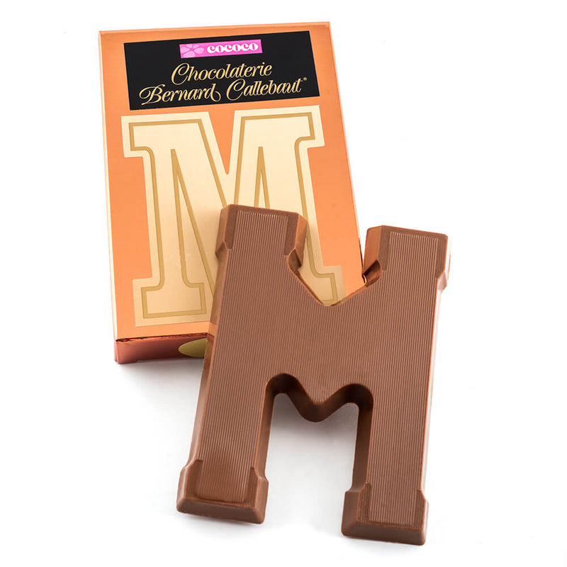 Milk chocolate letter M on top of it's Chocolaterie Bernard Callebaut®  box