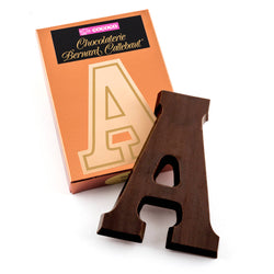 Dark chocolate letter A on top of it's Chocolaterie Bernard Callebaut®  box