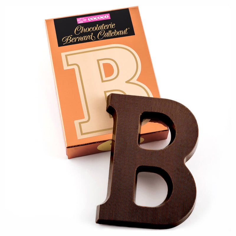 Dark chocolate letter B on top of it's Chocolaterie Bernard Callebaut®  box