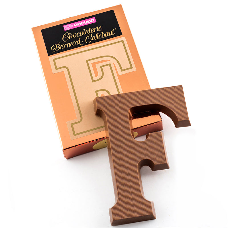 Milk chocolate letter F on top of it's Chocolaterie Bernard Callebaut®  box