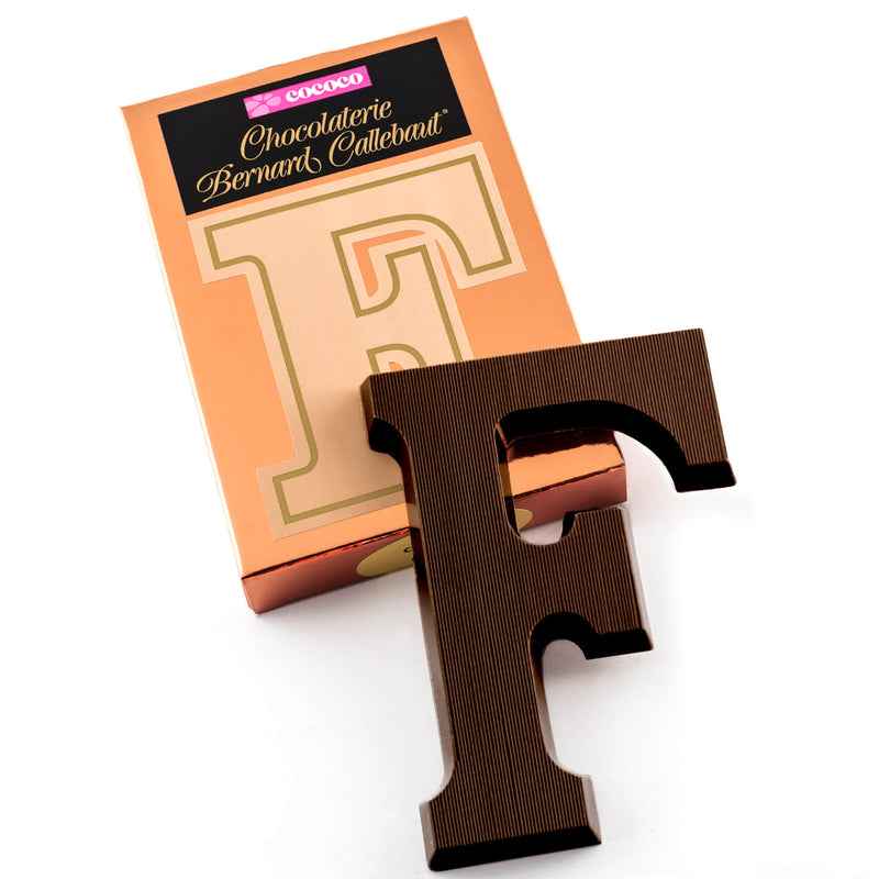 Dark chocolate letter F on top of it's Chocolaterie Bernard Callebaut®  box