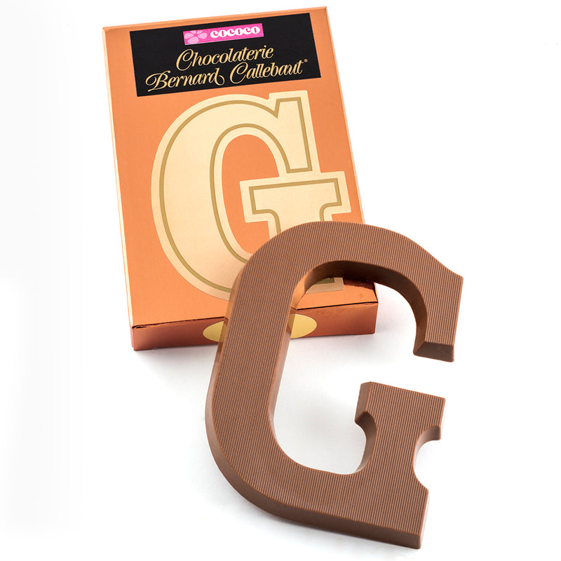 Milk chocolate letter G on top of it's Chocolaterie Bernard Callebaut®  box
