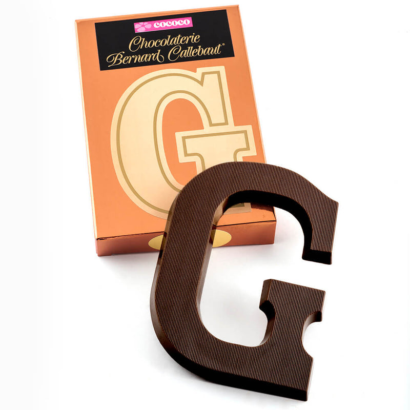 Dark chocolate letter G on top of it's Chocolaterie Bernard Callebaut®  box