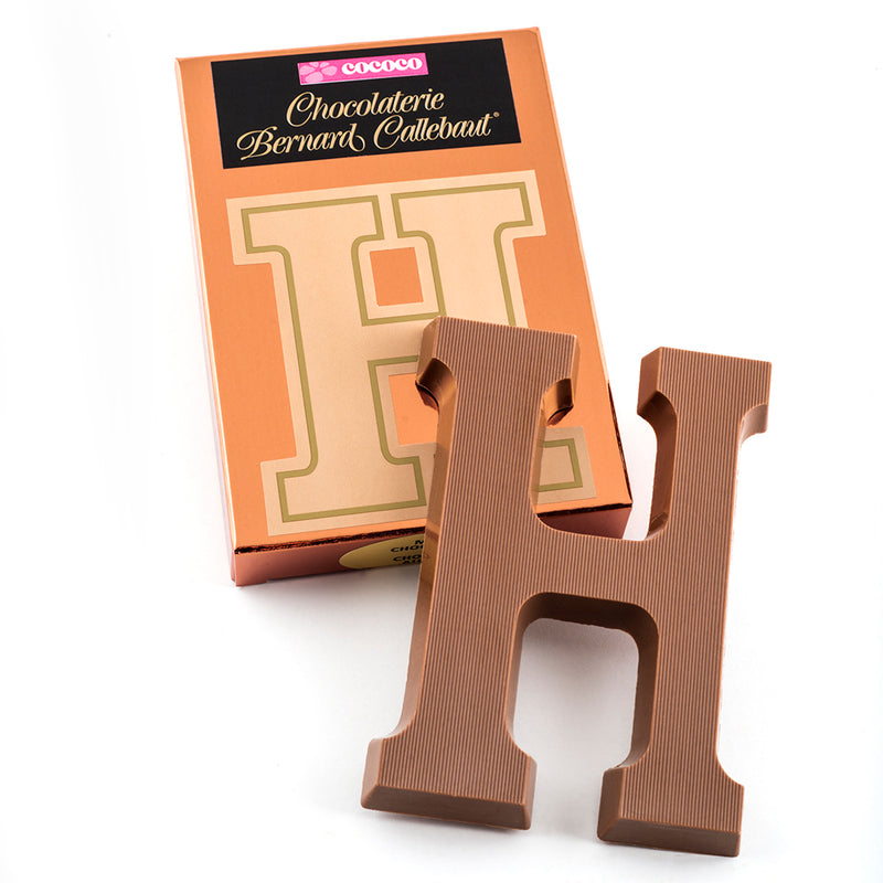 Milk chocolate letter H on top of it's Chocolaterie Bernard Callebaut®  box