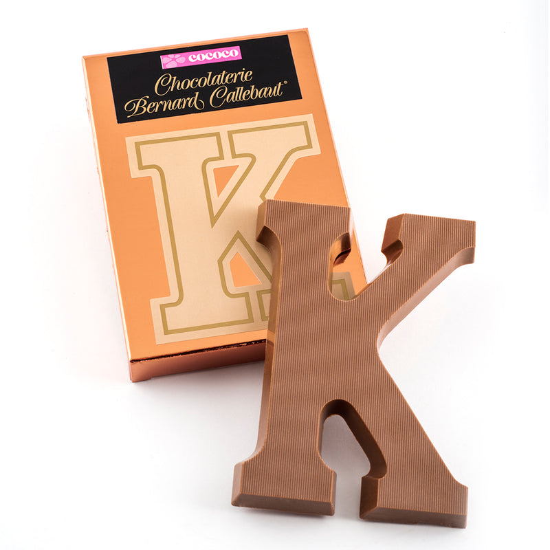 Milk chocolate letter K on top of it's Chocolaterie Bernard Callebaut®  box