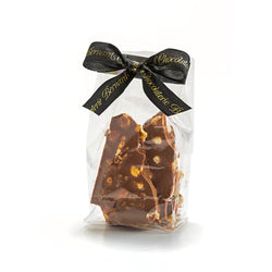Cello bag of milk chocolate nut bag tied with Chocolaterie Bernard Callebaut® branded black ribbon