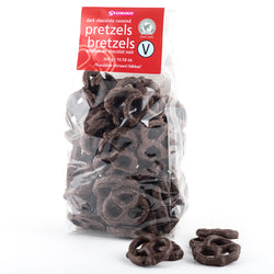 Bag of dark chocolate covered pretzels with a few pretzels in the foreground