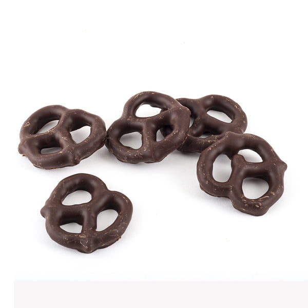 Five dark chocolate coated pretzels on a white background