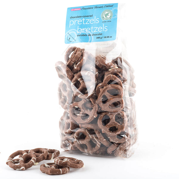 Bag of milk chocolate covered pretzels with a few scattered in front of the bag