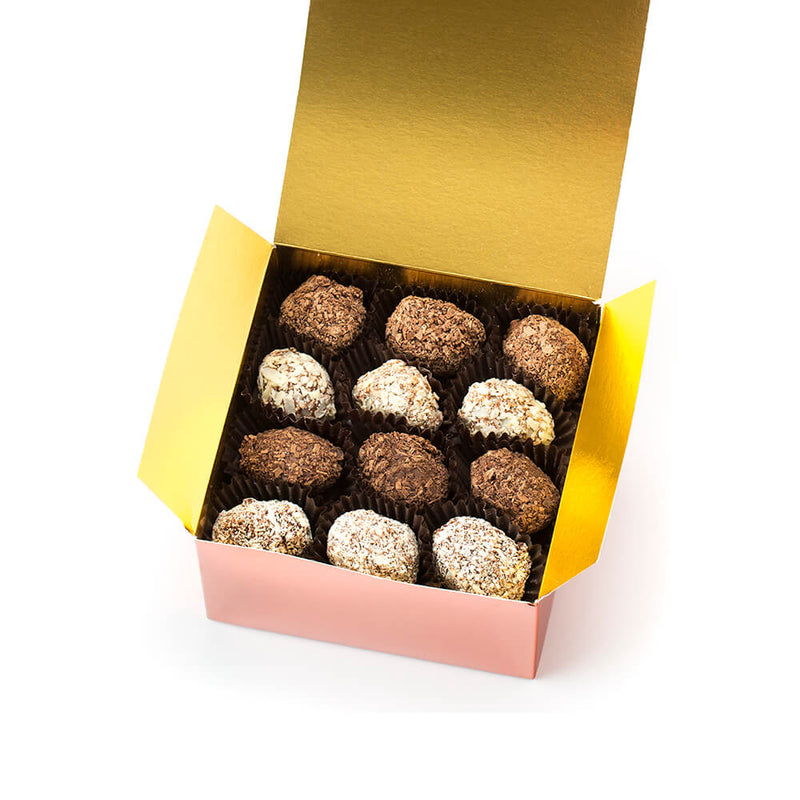 an open Chocolaterie Bernard Callebaut® copper box with 12 assorted truffles on top layer