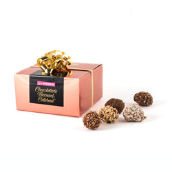 A Chocolaterie Bernard Callebaut® copper box with five truffles next to box