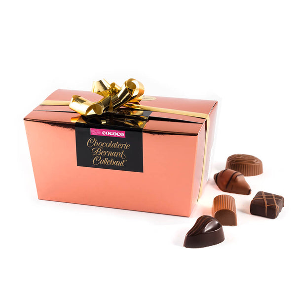 Chocolaterie Bernard Callebaut® copper chocolate box with gold ribbon and five chocolates next to box