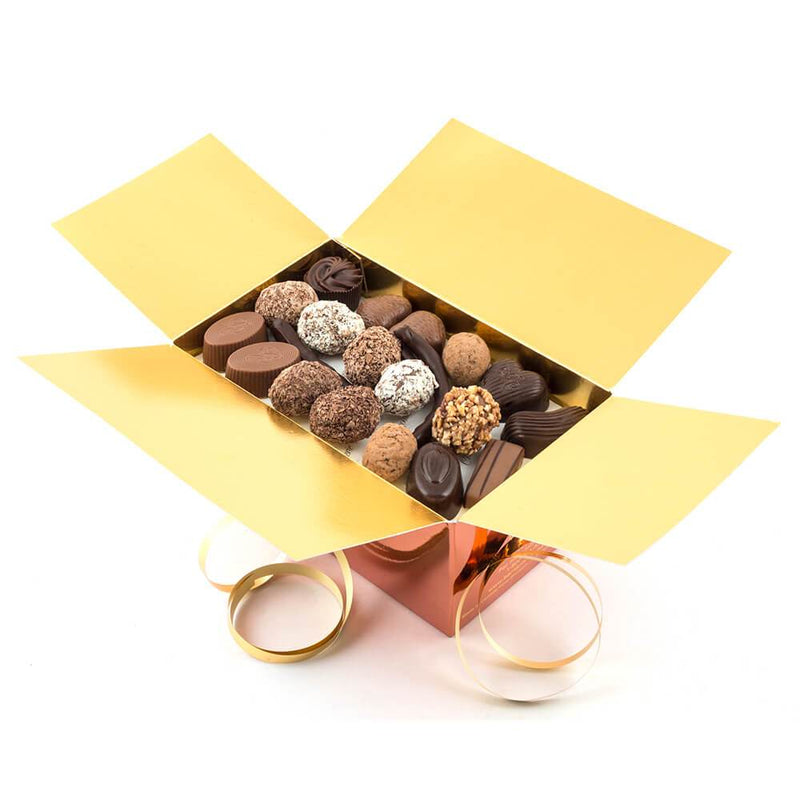 An opened Chocolaterie Bernard Callebaut® copper chocolate box with gold ribbon