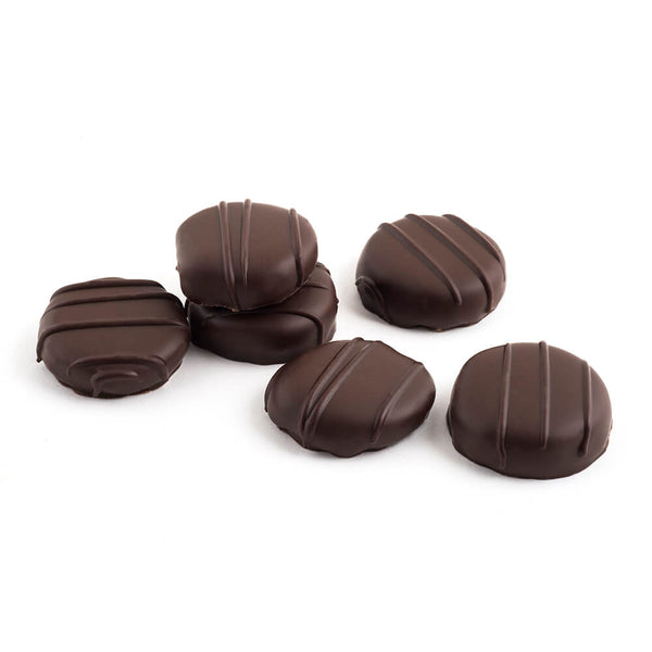 Six pieces of dark chocolate coated candied ginger